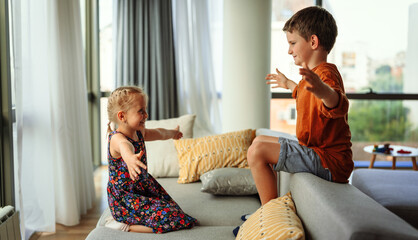 Little kids, siblings hug and cuddle at home show love and care. Family children support concept