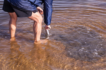 A man sucking up bait for fishing at Witsand, South Africa