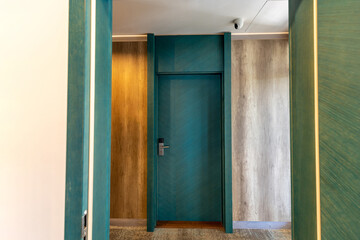 Wooden entrance door in hotel corridor