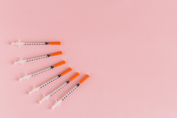 Several syringe on pink table prepared for injection in hospital