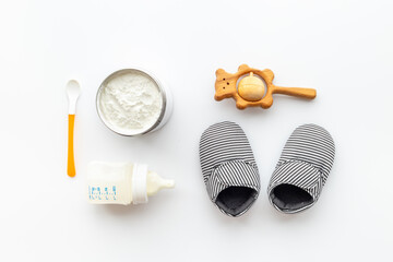 Feeding baby with milk formula - bottle of milk top view