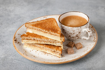 Cup of coffee and cheese toasted sandwich