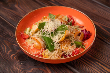 Caesar salad with chicken with grated cheese and cherry tomatoes