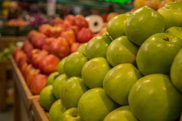 green apples in a row in a foodmarket