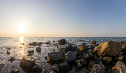 beautiful sunrise over the sea. foreground stone backgrounds