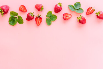 Group of ripe strawberries with green leaves. Flat lay