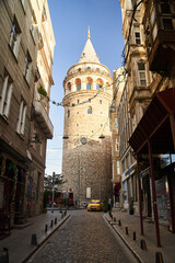 Istanbul, Turkey - May 2, 2021: View of the Galata Tower through the street.