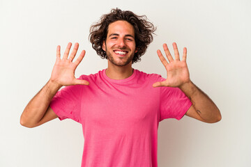 Fototapeta premium Young caucasian man isolated on white background showing number ten with hands.
