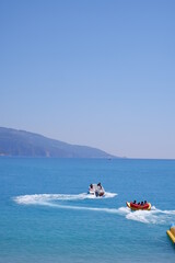 Mugla , Turkey - June 18th 2021 : tourists enjoying extreme sea sport with view of Oludeniz sea 