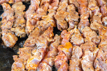 Cooking chicken skewers in a street festival. 