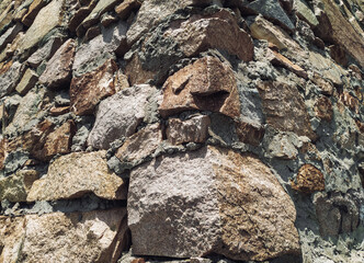 The masonry wall is made of large granite blocks.