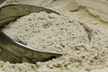 Powdered wheat flour with a steel bowl in it.