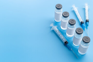 Covid vaccine in bottles with syringe. Top view