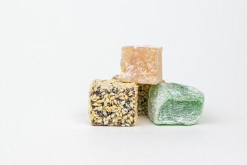 Slices of Turkish delight on a white wooden table.