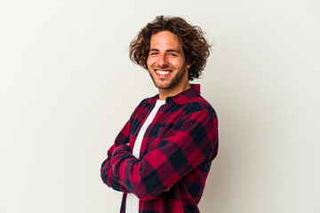 Young caucasian man isolated on white background who feels confident, crossing arms with determination.