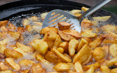 potatoes are fried in oil. Freshly cooked popular food. Side dish