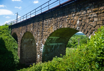 the old railway bridge is built of stone. historic building used
