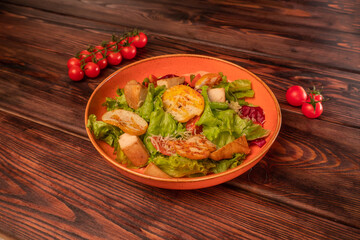 Caesar salad with chicken with grated cheese and cherry tomatoes