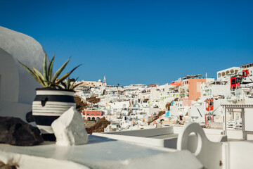 Santorini island Fira or Thera town landscape. Traditional greek white houses on hill. Summer...