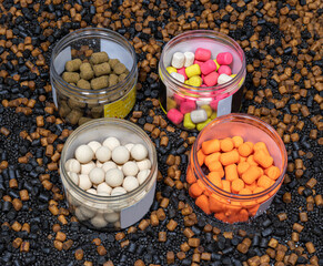 pots of hook baits including pop ups and wafters on a bed of pellets