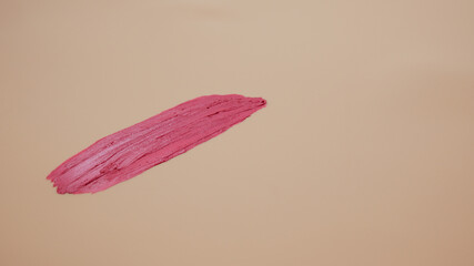 Lipstick smudge on nude background