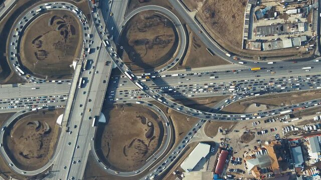Aerial intersection of several roads, aerial view of the roundabout. Highway panorama in the evening at sunset. Leading innovation concept, finance abstraction, transport logistics and infrastructure.