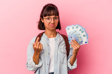 Young mixed race student woman holding bills isolated on pink background pointing with finger at you as if inviting come closer.