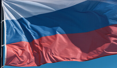 Flag of the Russian Federation flutters in the wind. The concept of national symbols, international relations, Olympic and sports games. Close up shot