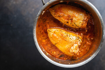 pepper filling rice and vegetables tomato sauce stuffed cabbage rolls fresh vegetable in plate on the table meal snack copy space food background rustic. top view keto or paleo diet 