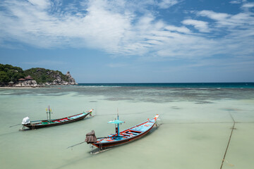 Fototapeta na wymiar Long Tail Boats Tied Up In Shallow Water on Sairee Beach, Koh Tao, Thailand