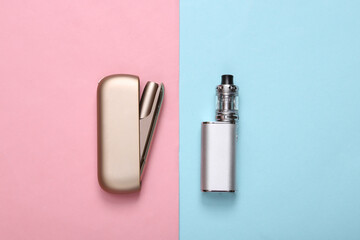 Tobacco heating system and vaping device on blue pink pastel background. Top view