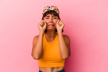 Young mixed race woman isolated on pink background whining and crying disconsolately.