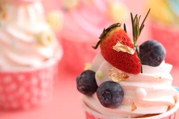 Colorful cupcakes isolated in pink background