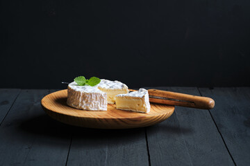 Camembert cheese with black background