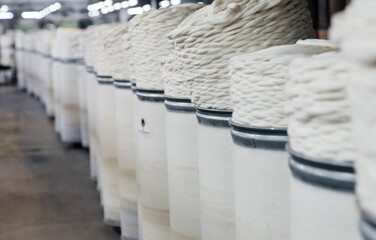 White cotton yarn in plastic barrels at production.