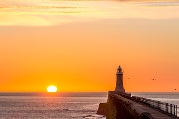 Tynemouth Pier and the Lighthouse with a beautiful vibrant sunrise