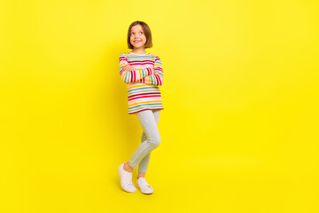 Fototapeta na wymiar Full length photo of pretty short hairdo small girl crossed arms look empty space wear shirt trousers isolated on yellow color background