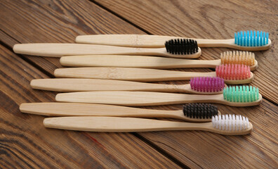 Eco bamboo toothbrushes on wooden background