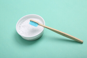 Eco bamboo toothbrush and tooth powder on blue background