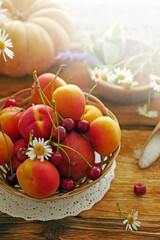 Summer ripe fruits peaches, apricots, cherries on a wooden table. Summer food background, copy space