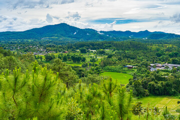 Fototapeta na wymiar Greenery of rice fields and hill tribe villages in the rainy season of Chiang Mai, Thailand.