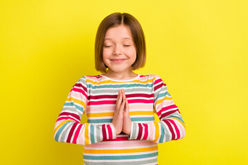 Photo of calm little happy cheerful positive girl hands pray make wish present isolated on shine yellow color background