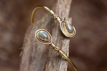 Brass metal mineral stone detail elegant bracelet on natural background