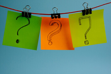 Question marks drawn on colorful rainbow stickers.