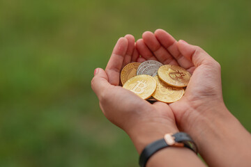 Hand with coins. Bitcoin. Savings concept.