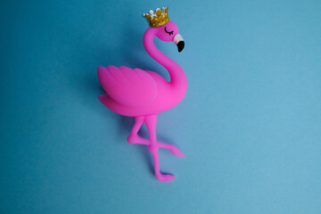 Pink flamingo in a gold crown on a blue background.