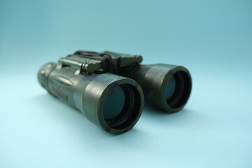 Binoculars  on a blue background.