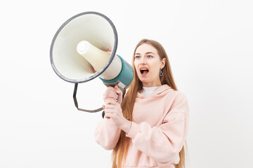 Young caucasian woman shouting into loudspeaker isolated on white background