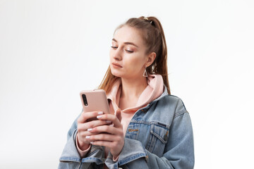 Young attractive caucasian woman using smartphone isolated on white background