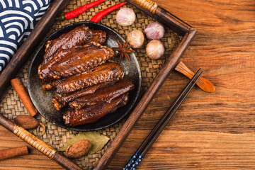 The duck's wings were boiled and placed on a  plate